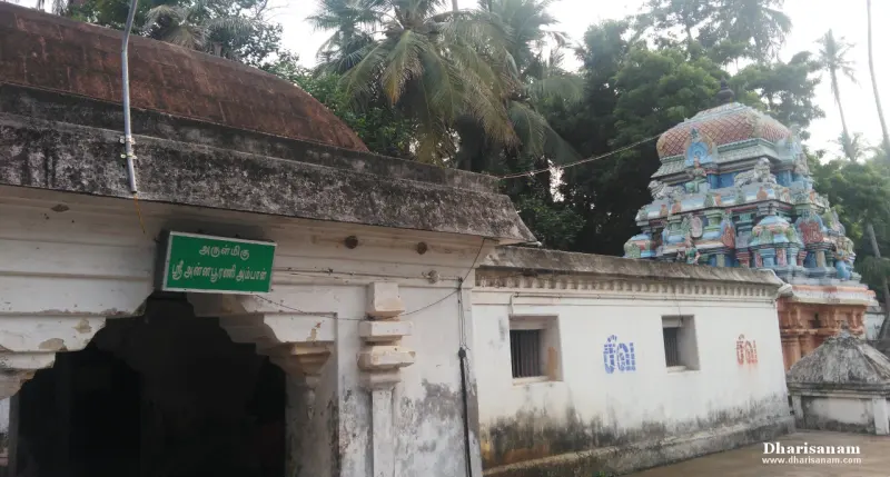 A shrine entrance under a green board naming the Annapoorani Ambal, with the coloured tower on the right