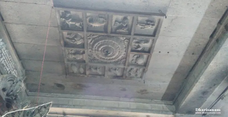 A square of carved zodiac panels around a round lotus-like centre on a stone ceiling