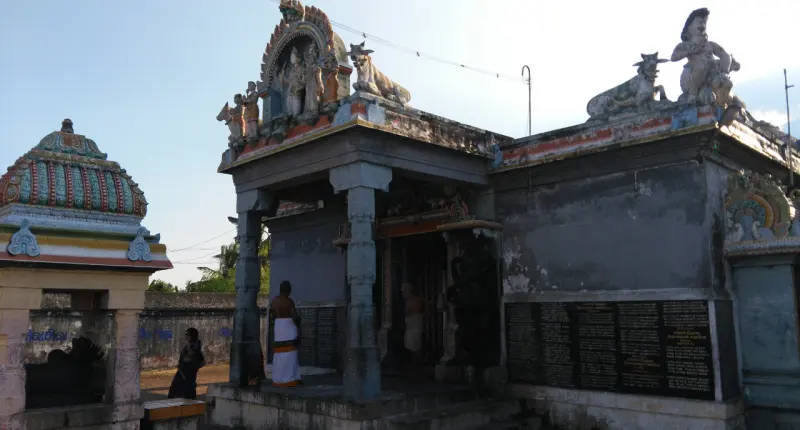 Stone porch with a pillar and black inscription panels on the wall beside it