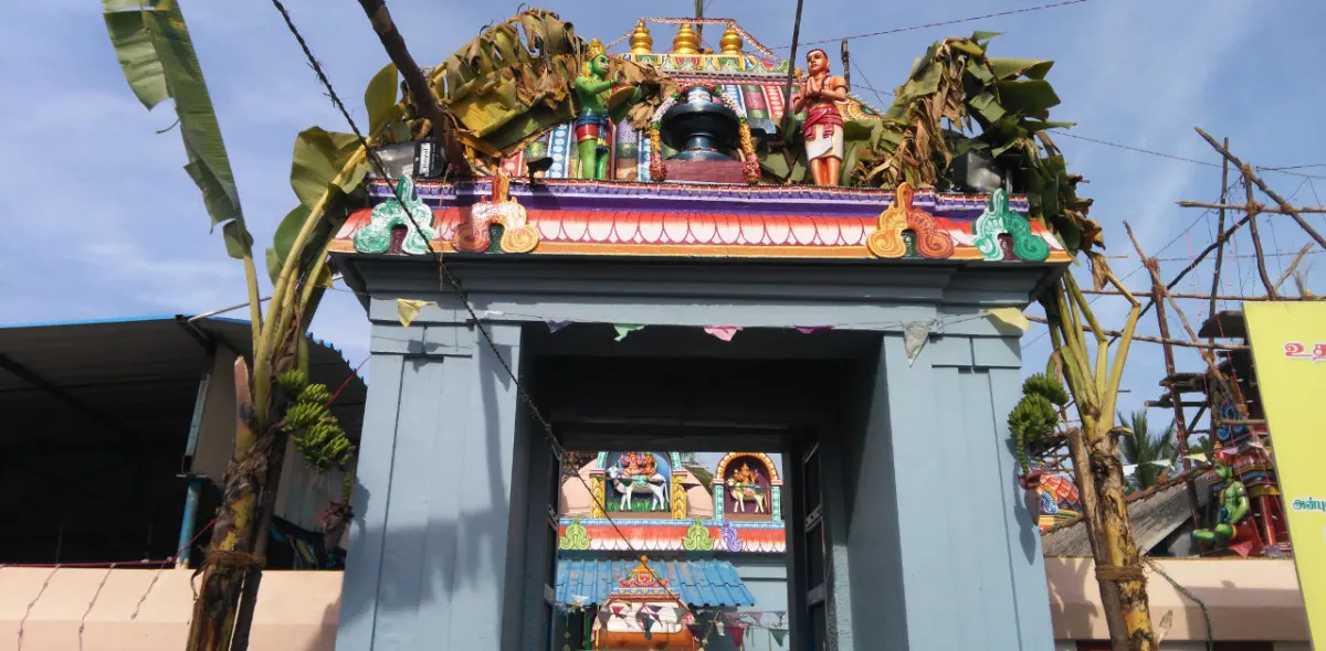 Entrance arch with colourful deity figures and plantain stems tied each side