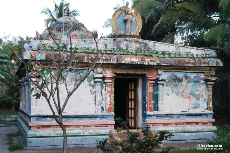 Small shrine with painted wall panels, an open door and a figure in a golden arch above the roof