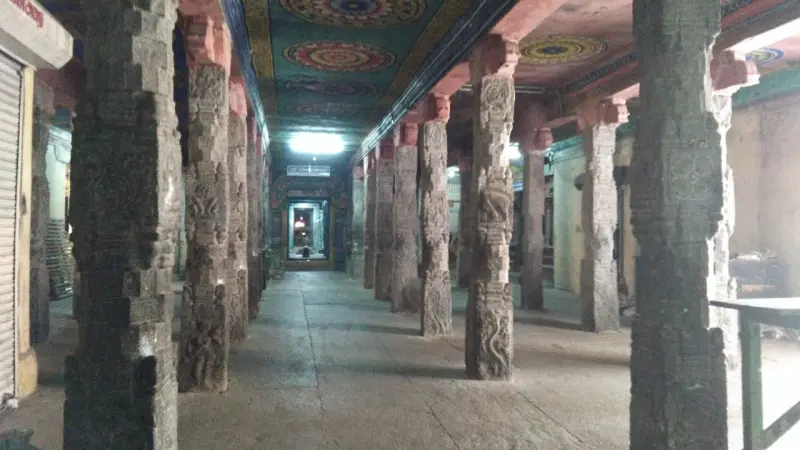 Long hall of carved stone pillars leading to a shrine