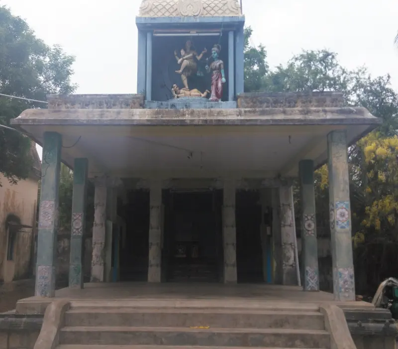 A pillared hall with steps, statues of deities on the roof parapet