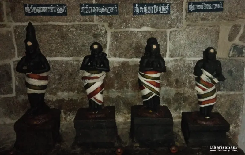 Four standing saint idols in striped cloths with Tamil name boards