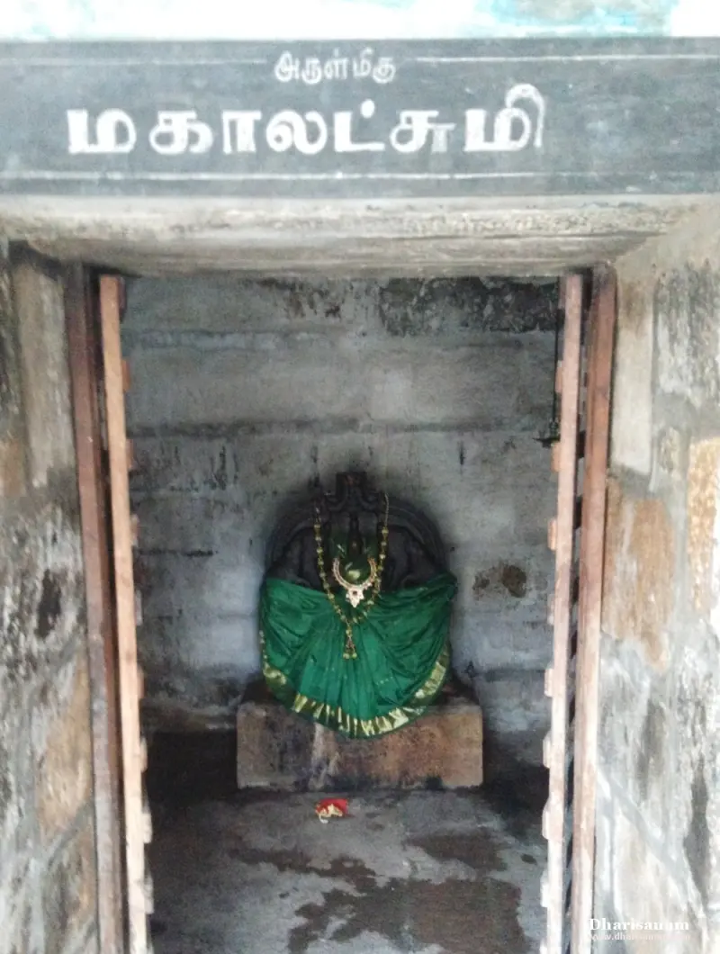 A small shrine with an idol in a green cloth and a garland, under a name board reading Mahalakshmi.