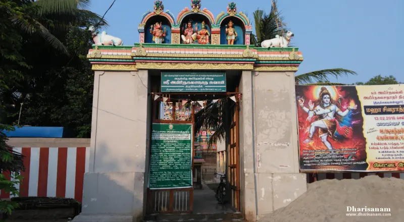 Gate topped with deity sculptures and Nandi statues, Tamil boards below