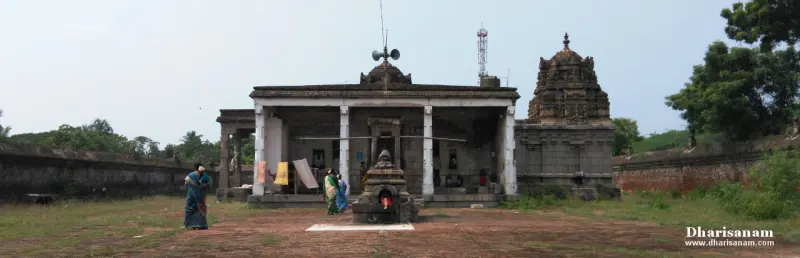 A small stone pavilion with a Nandi in the foreground, and a columned hall and a tower behind it.