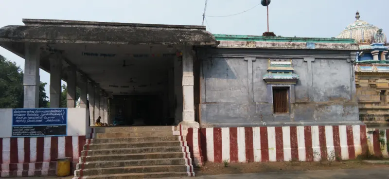 A pillared hall with steps and a red-white striped base