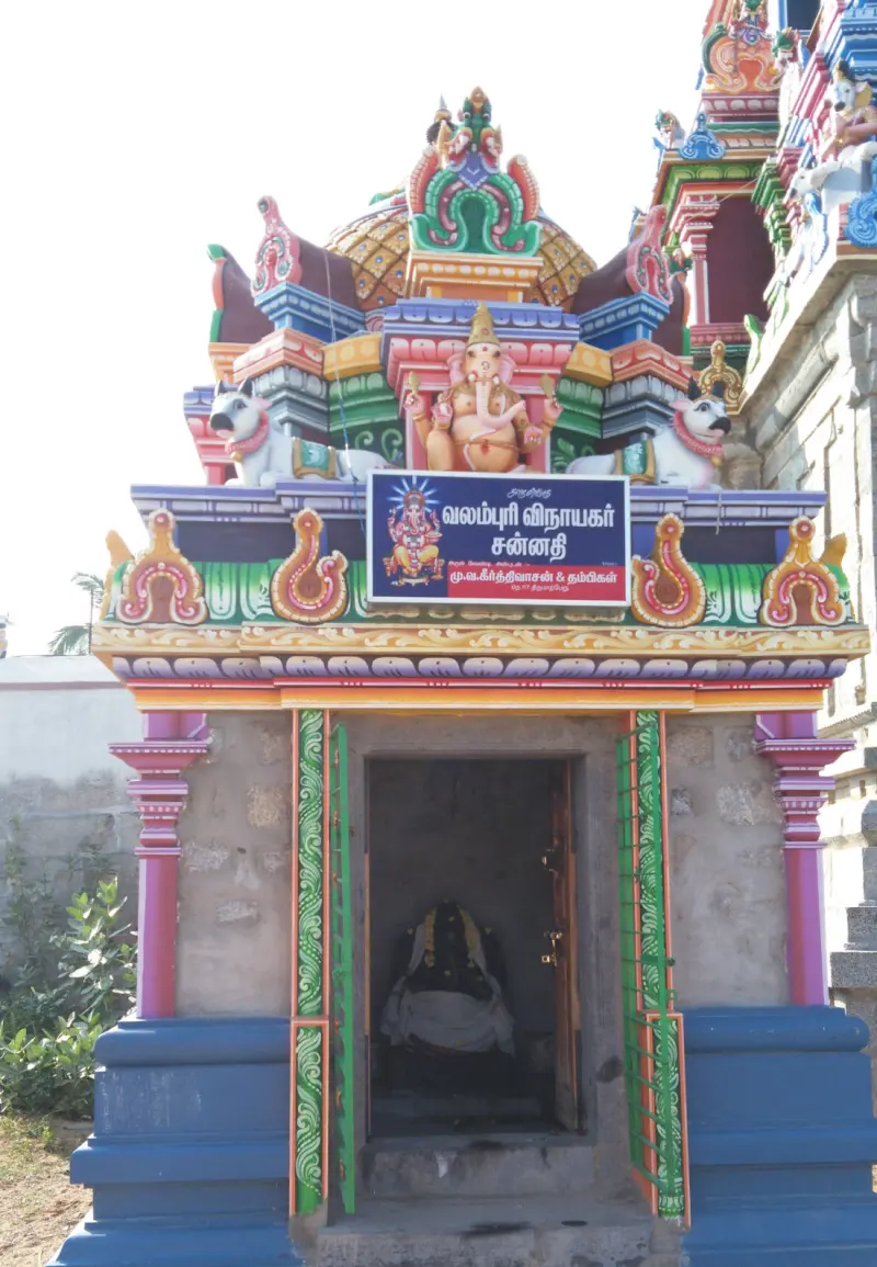 Small colourful shrine with a Vinayakar board and painted tower