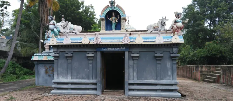 A shrine with bull statues and a goddess niche on its parapet