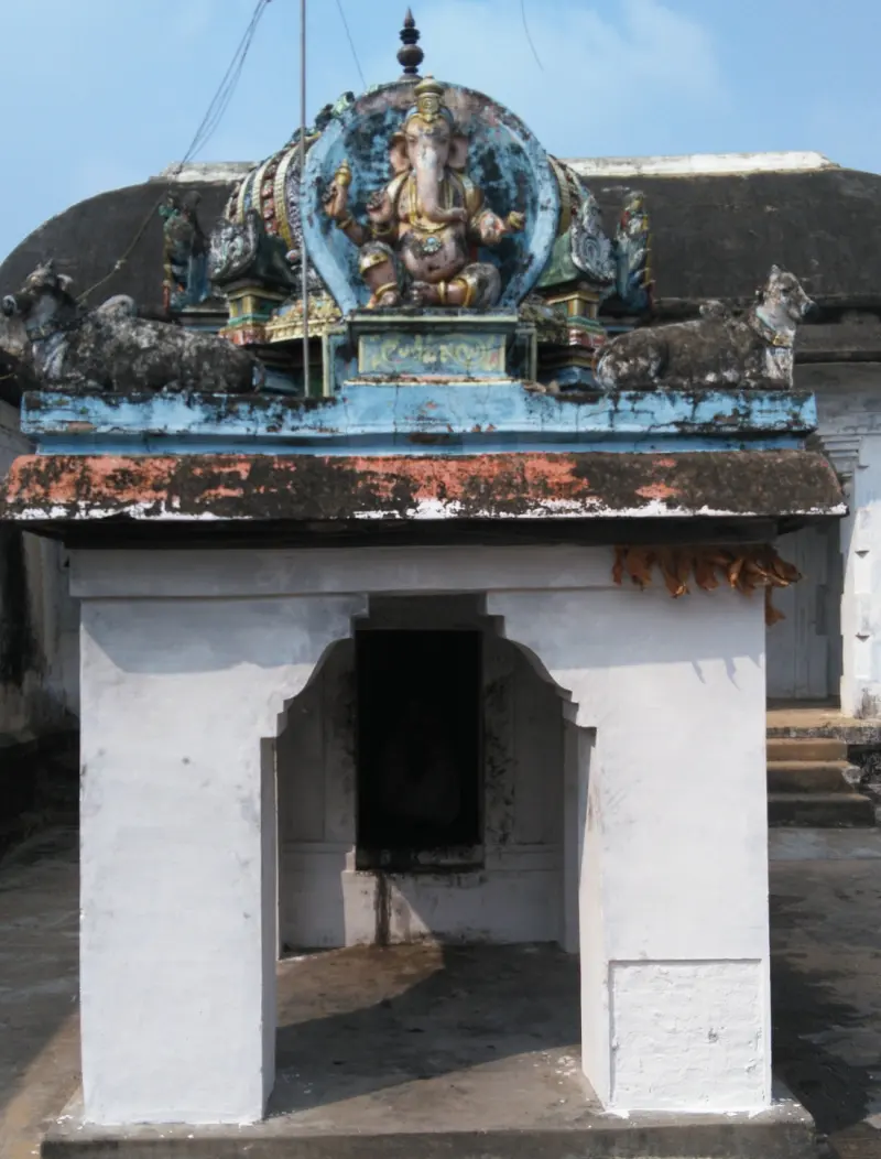 Small white shrine with Ganesha and two Nandis on top