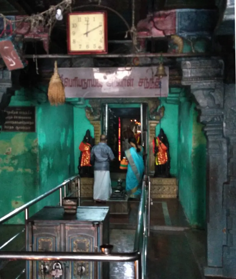 Green doorway with devotees entering the goddess shrine
