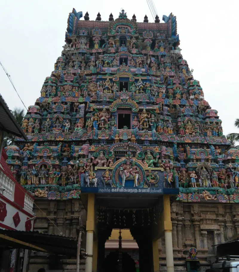 Huge tower crowded with colourful statues over a gate