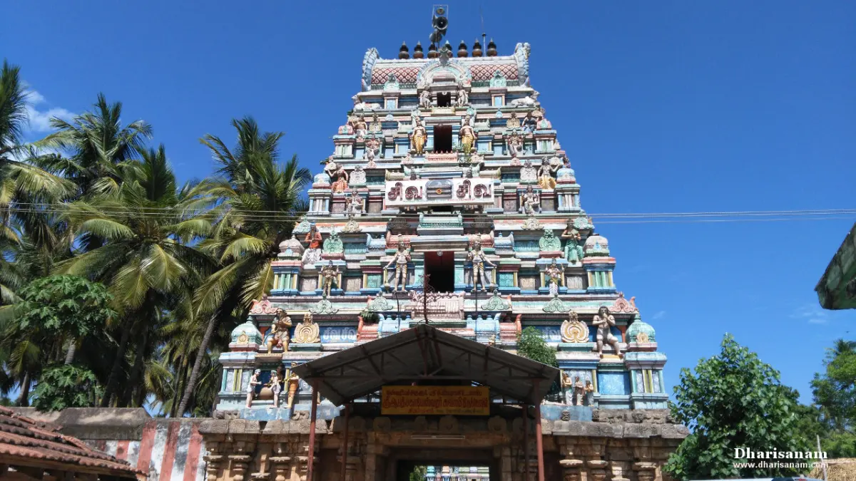 The colourful five-tier Rajagopuram rising above the entrance gateway, with palm trees on the left