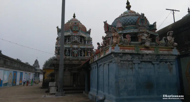 Two domed roofs decorated with painted figures, one on a blue-painted wall, with a corridor at the left