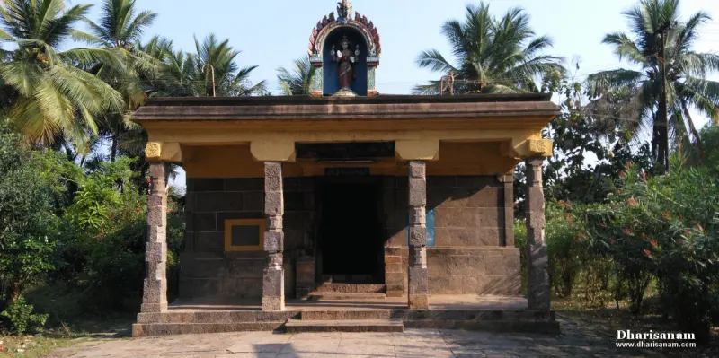 A stone shrine with pillars and a niche figure above