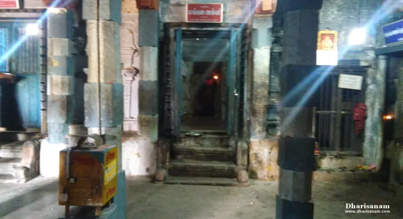 Stone steps rising between pillars to a dark doorway