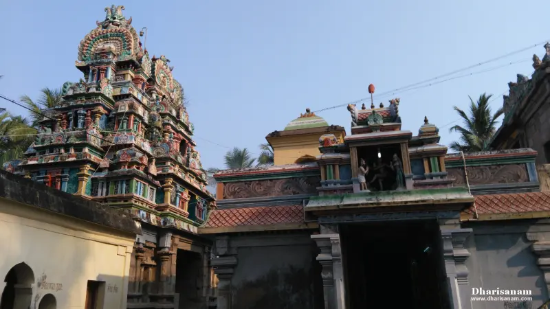 A tower and entrance porch with sculptures above the door