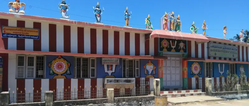 The red and white striped outer wall with figures on top