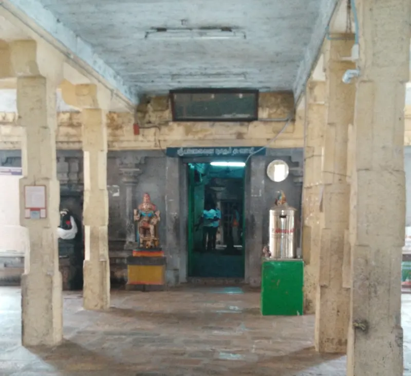 A pillared passage with a Vinayakar statue leading to the shrine door
