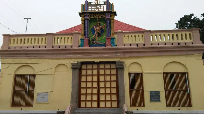 Yellow shrine with a dancing god on its red roof