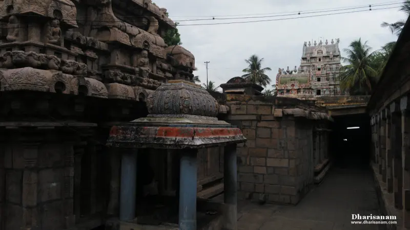 Domed mini shrine on pillars in a corridor with the tower behind