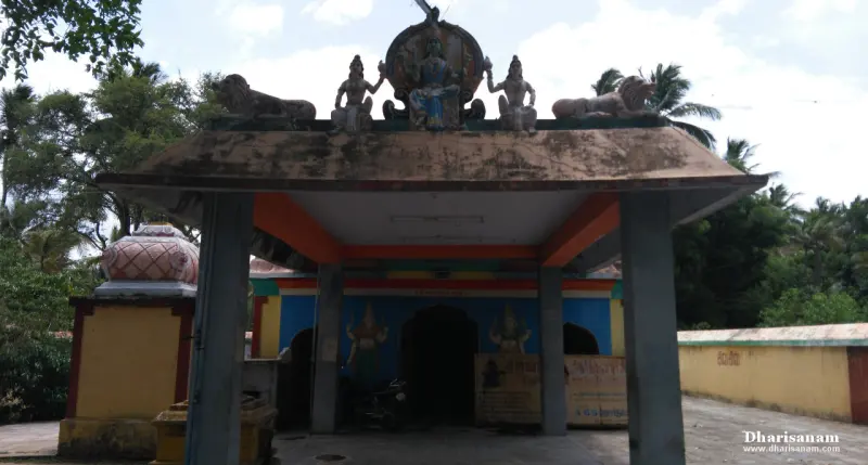A porch with lion and standing figures on its roof, and the blue shrine front with painted goddesses behind