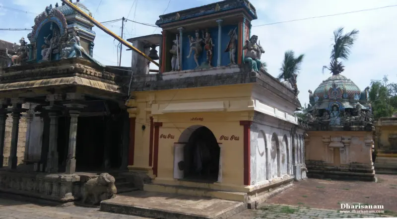 Small yellow-walled shrines with painted figures above, and a domed shrine roof at the right