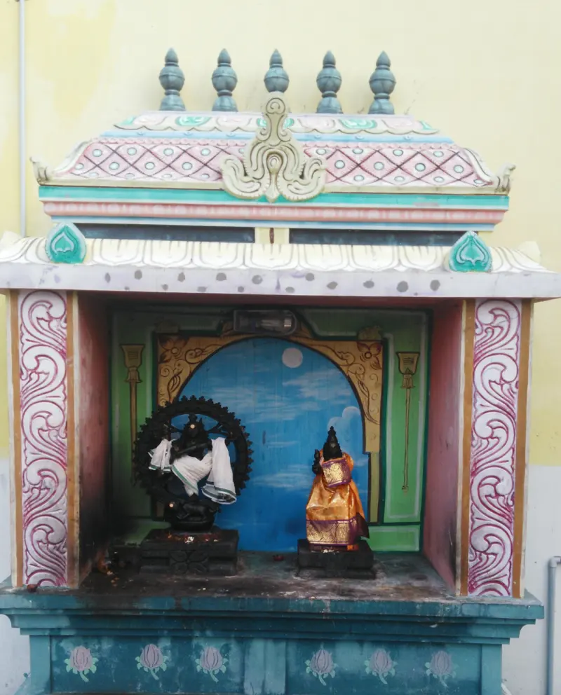 Black stone Natarajar and draped Sivakami in a painted shrine