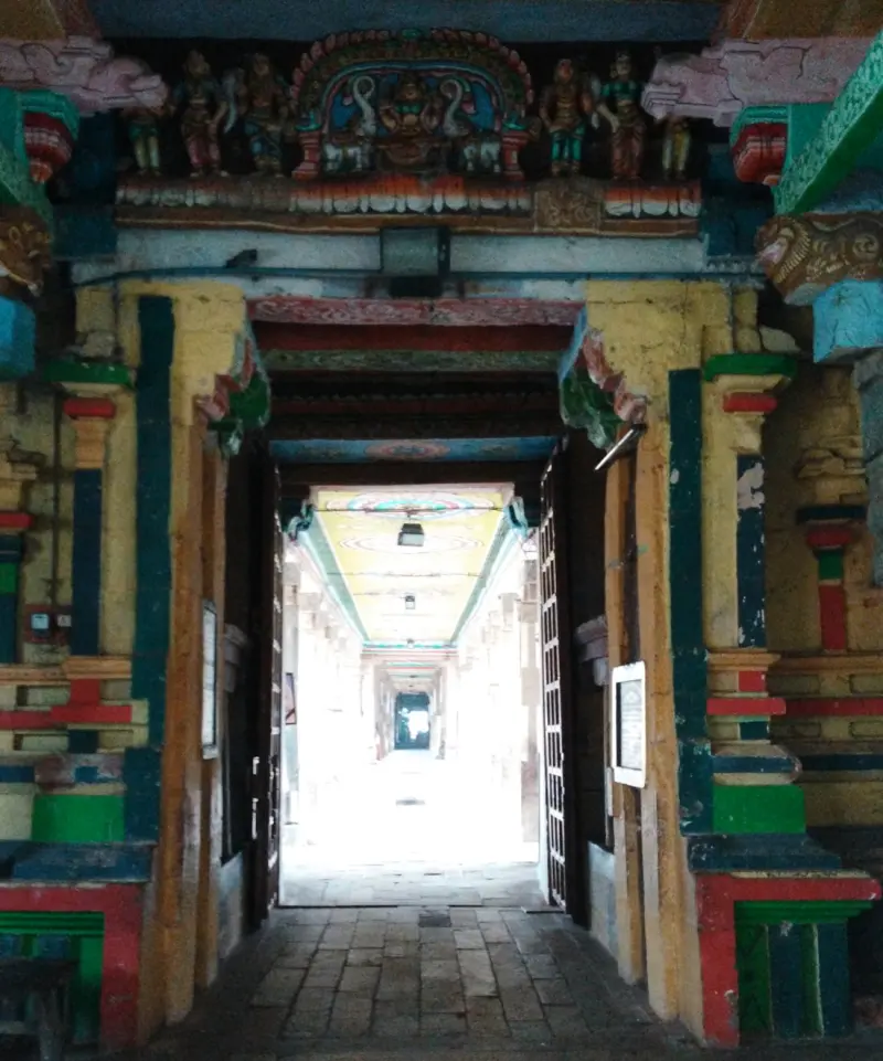 Long passage under painted beams and deity figures
