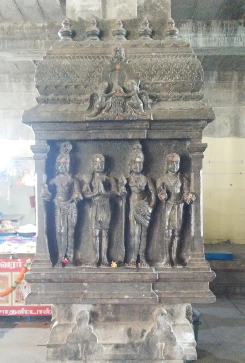Four standing saints carved on a small stone shrine
