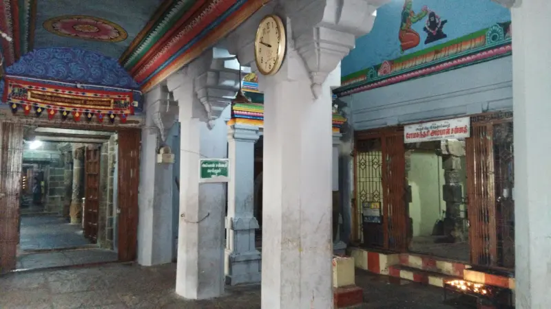 White pillars, wooden doors and rows of small lamps