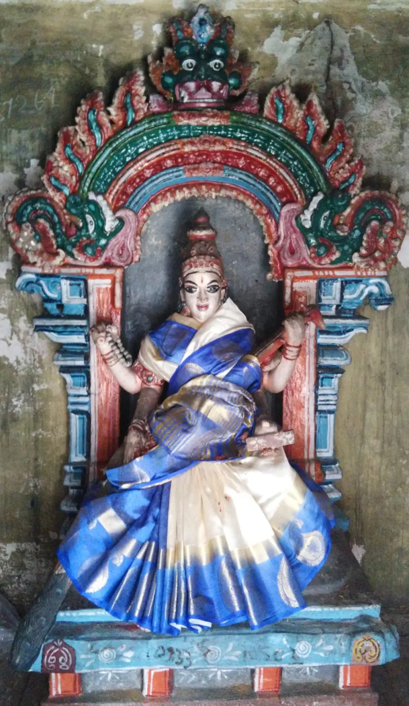 Four-armed goddess in blue and white holding a veena