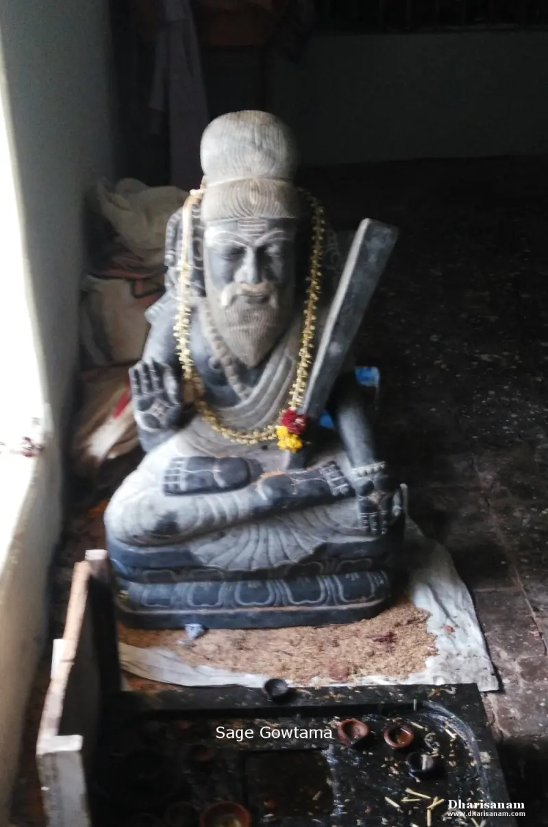 A seated stone figure of a bearded sage with a raised hand and a flower garland, labelled Sage Gowtama