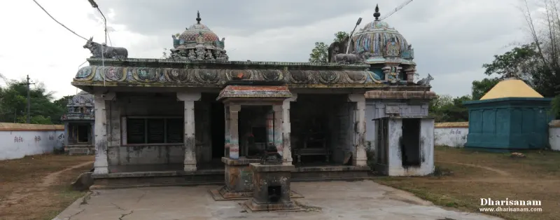 A long pillared hall with sculpted roof edges, a Nandi at either end and a domed tower behind.