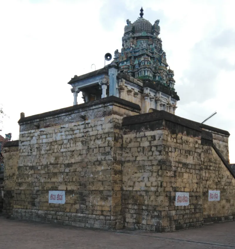 Shrine with a green tower standing on a high base of large stone blocks