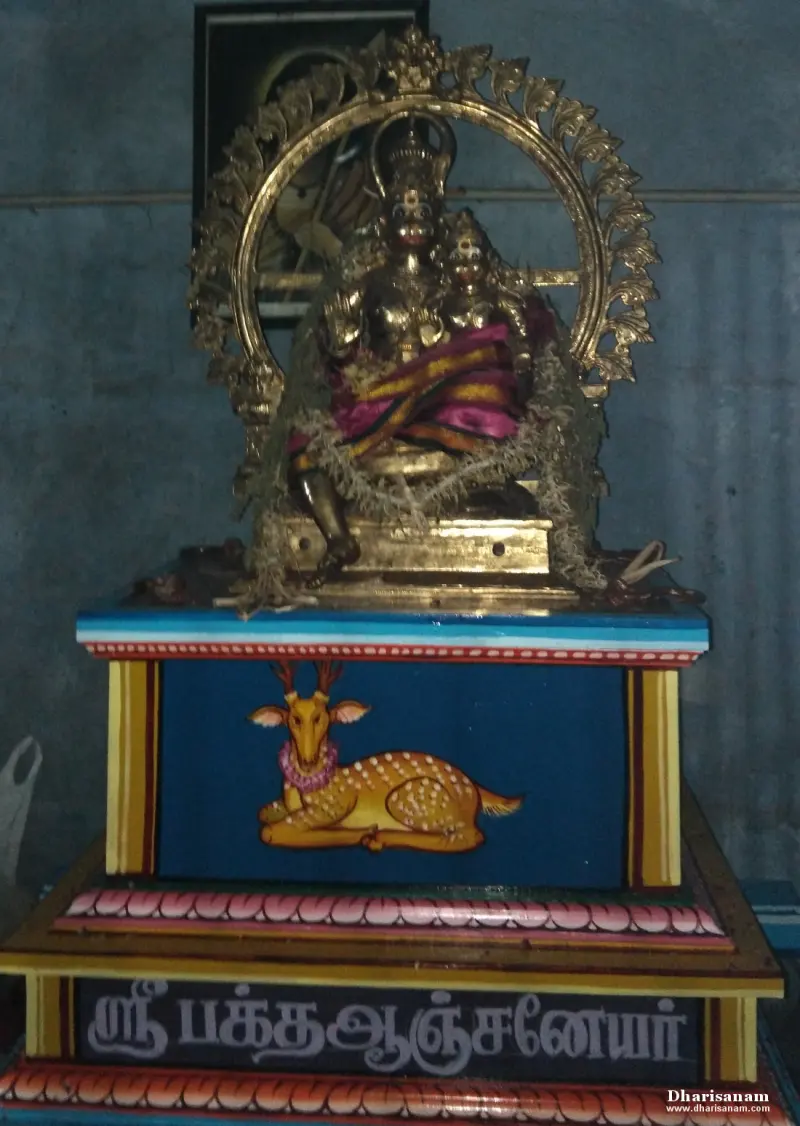 Gilded seated idol before a golden arch, on a blue stand painted with a deer, name board beneath