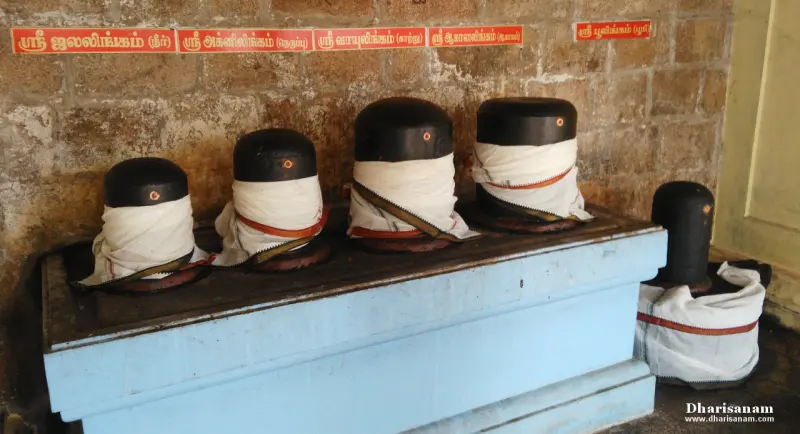 Five lingams wrapped in white cloth with Tamil name boards