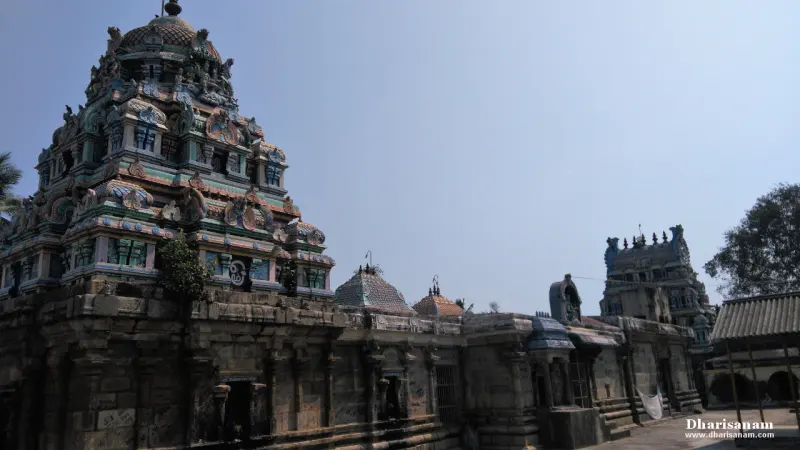 Old stone temple walls with a painted tower on the left and another tower far right