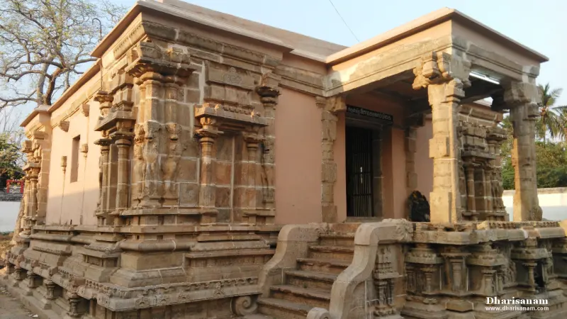 Stone shrine with a porch supported by pillars and steps leading up, under a blue sky