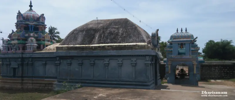Blue-walled shrine with a large domed roof, a painted tower behind it and a small shrine at the right