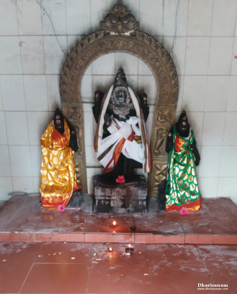 A dark central image in white cloth under an arch, with a smaller image in gold cloth and one in green