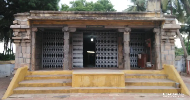 Stone pillared hall behind metal gates, approached by yellow steps