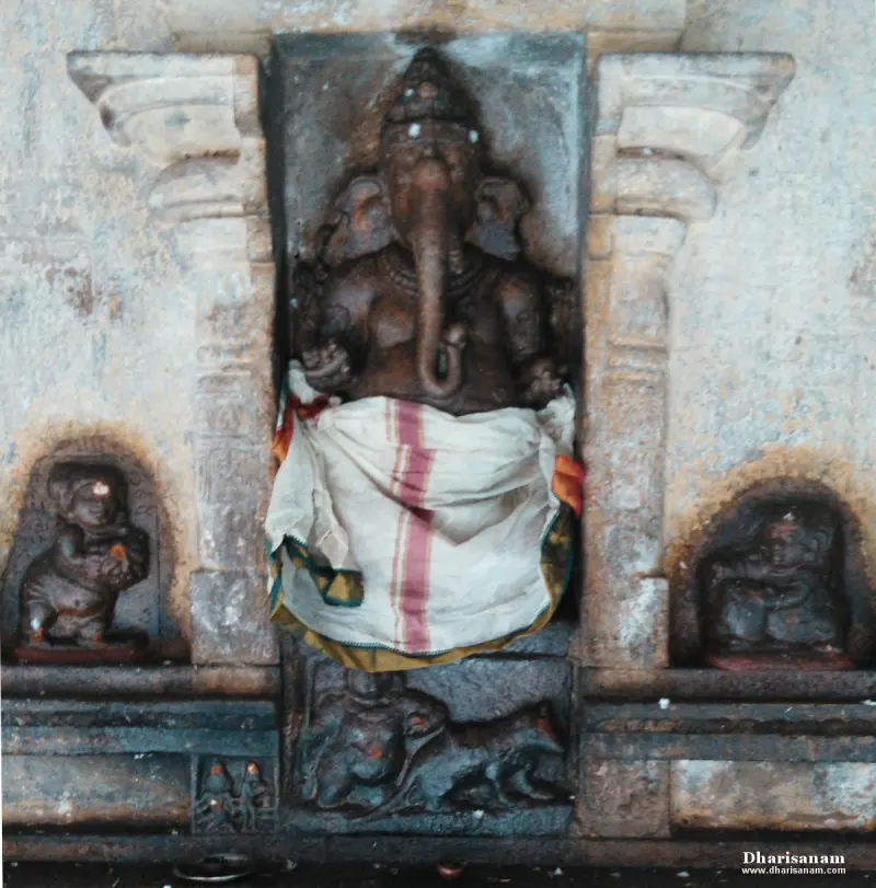 Stone Vinayakar in a niche, with small carved figures in alcoves on either side