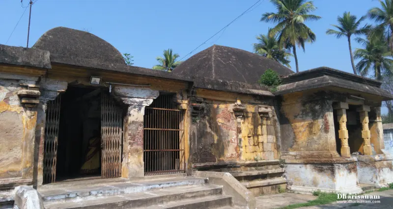 Weathered domed roofs over shrines with grille doors, palm trees behind