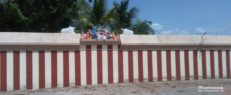 A long wall painted in red and white stripes with a group of painted figures and two white bulls on top