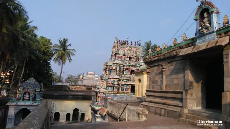 Temple towers and corridor roofs among palm trees