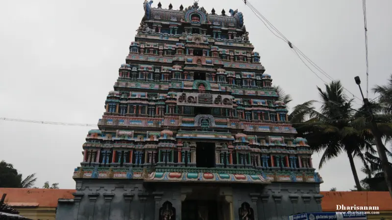 Front view of the tiered Rajagopuram, painted in many colours, under an overcast sky